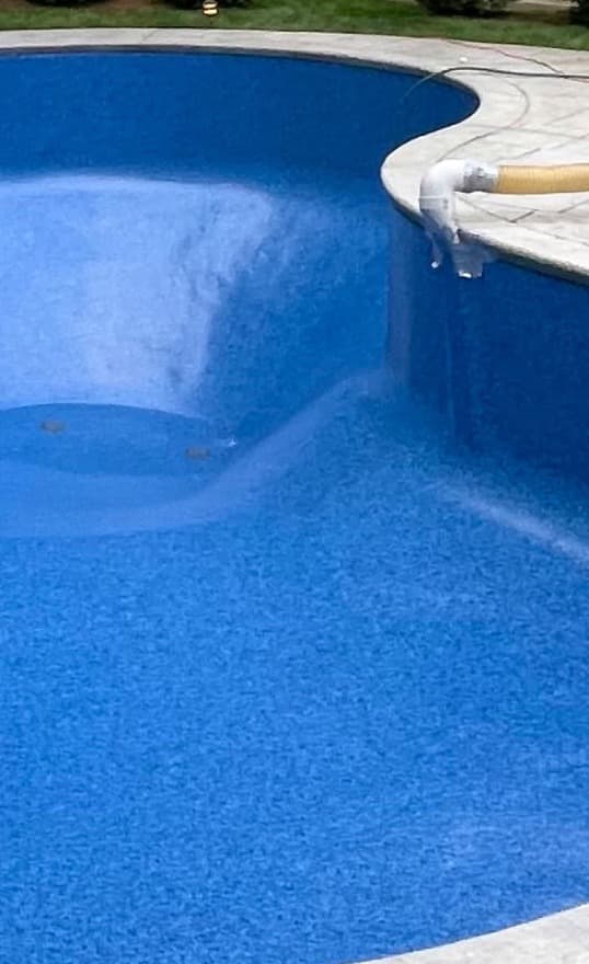 The same pool refilled with a bright new blue vinyl liner